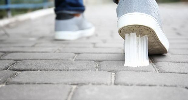 Gum is stuck on the bottom of someone's shoe