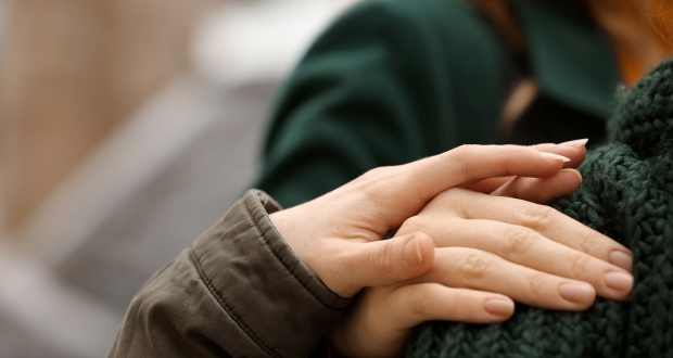 A woman putting her hand on a shoulder