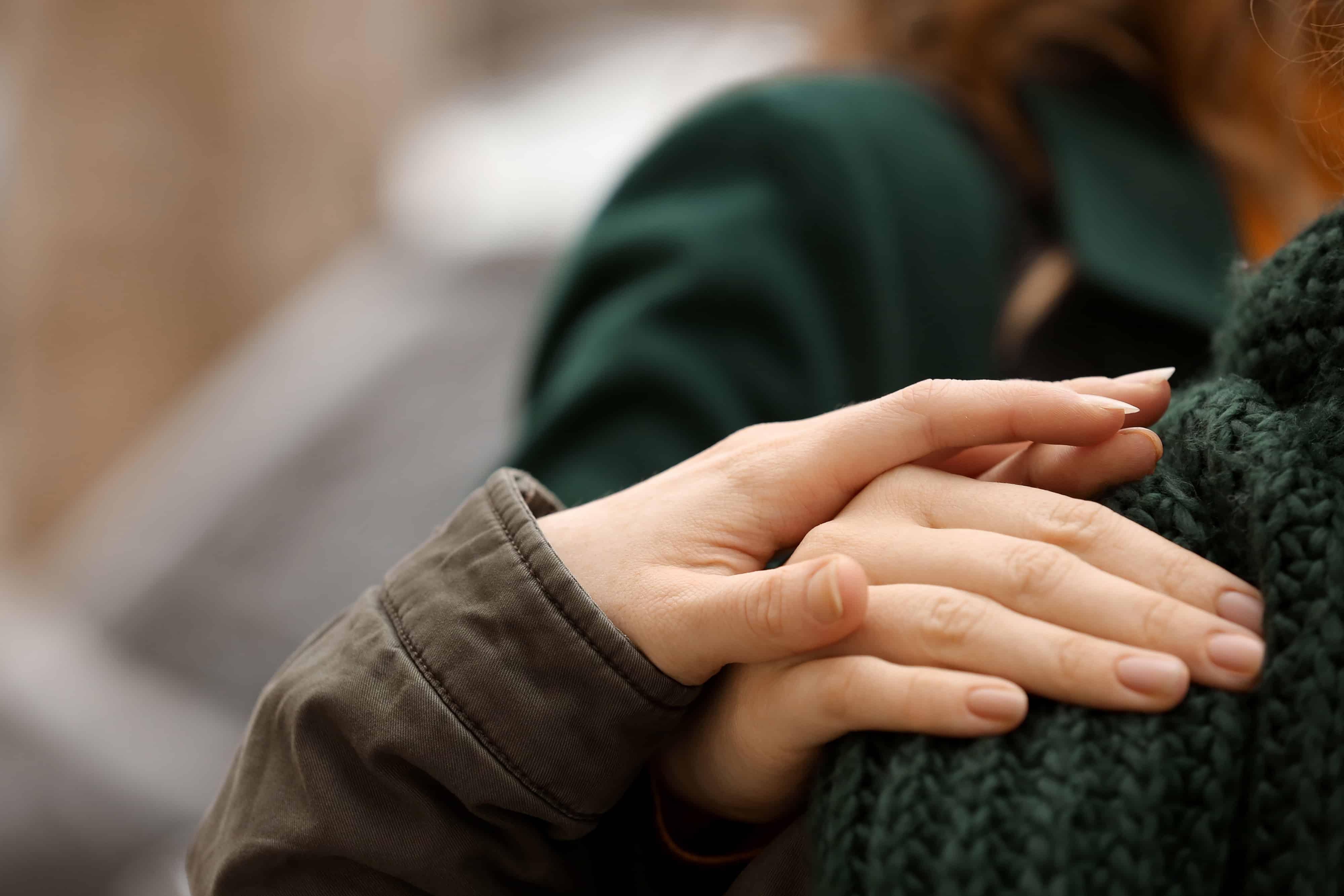 A woman putting her hand on a shoulder