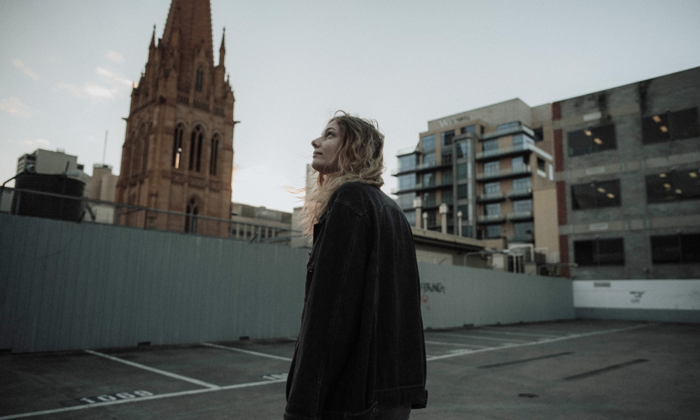 Woman staring at a church