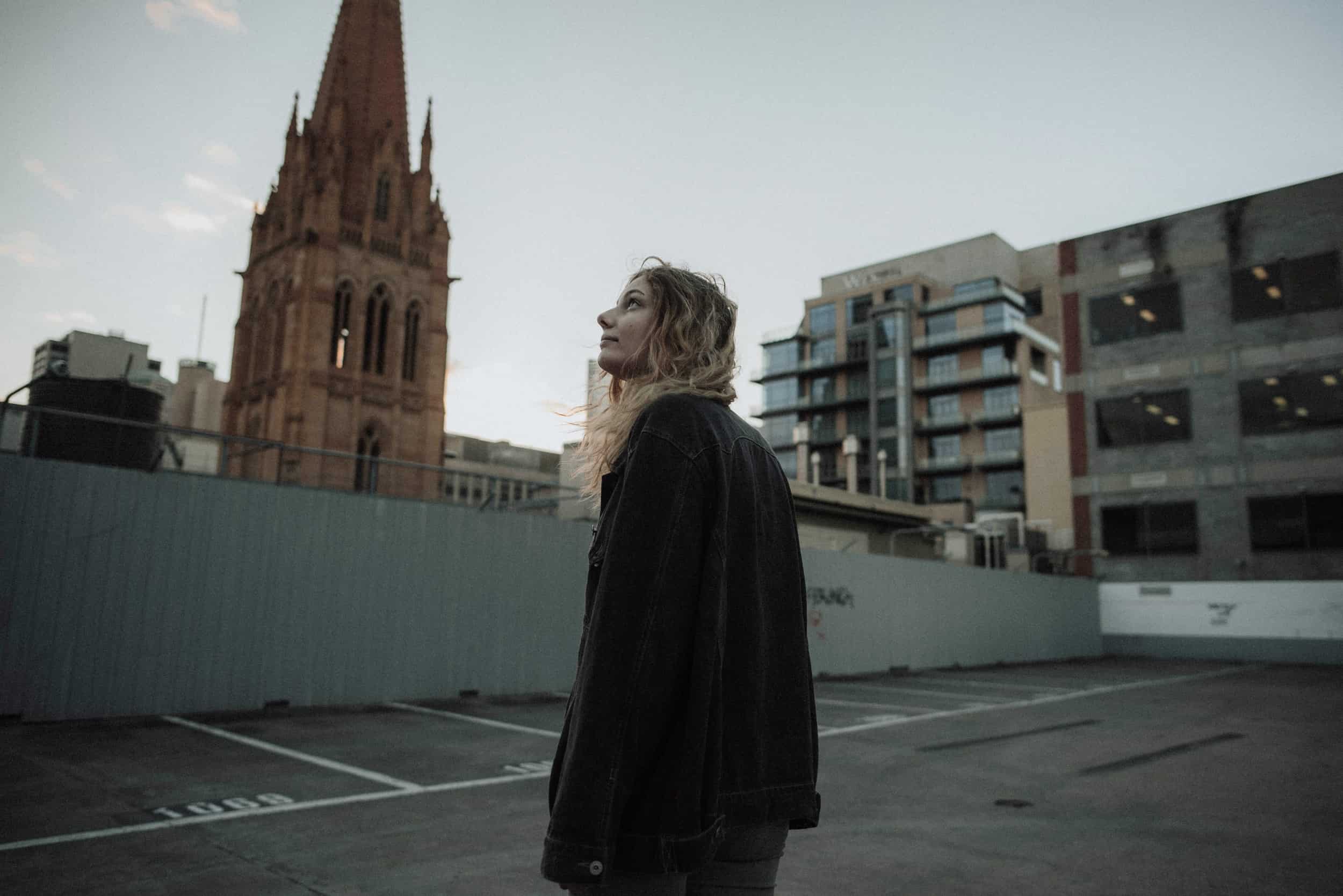 Woman staring at a church