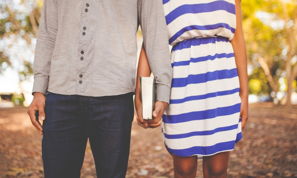 Christian dating couple holding a Bible