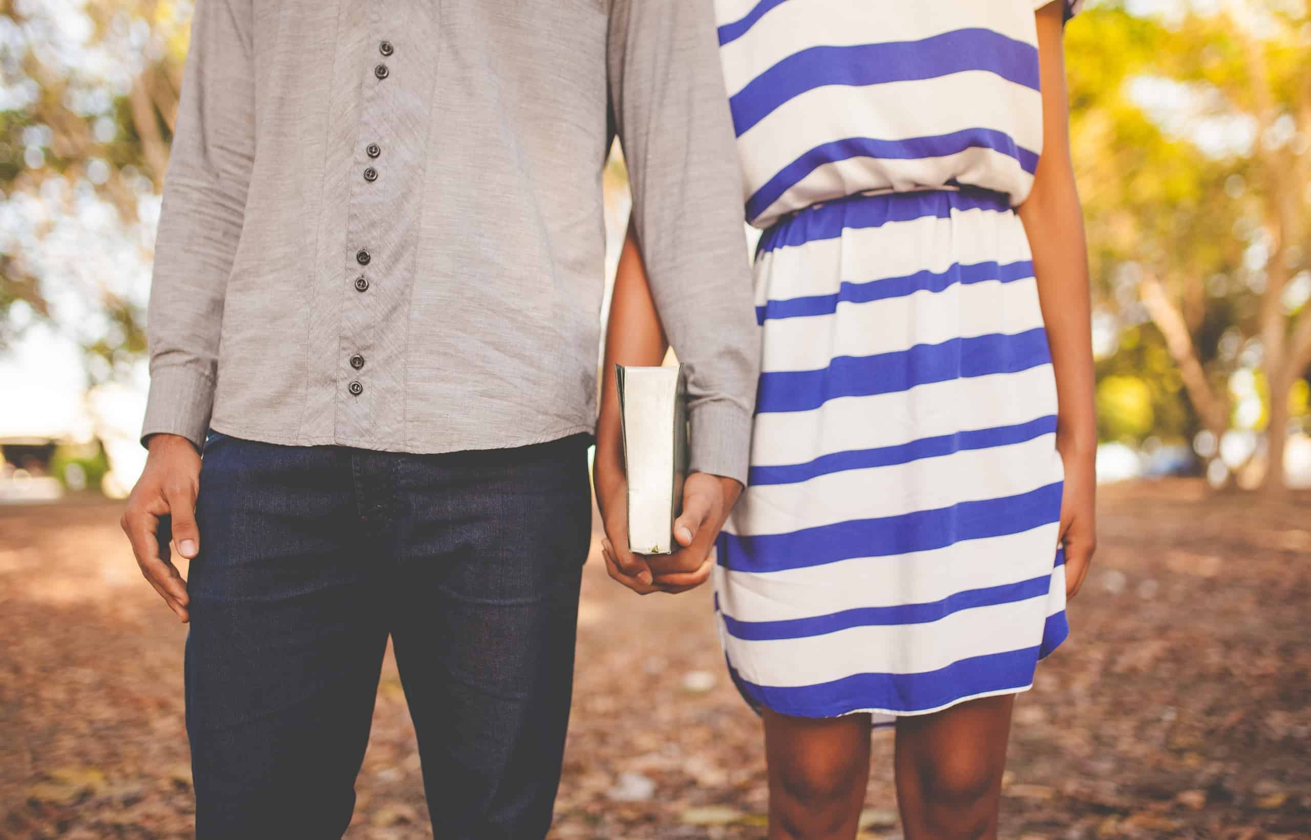 Christian dating couple holding a Bible