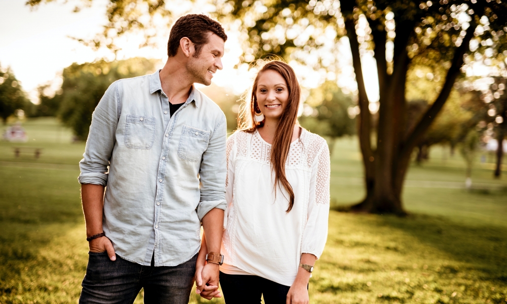 A married couple standing in the sunlight