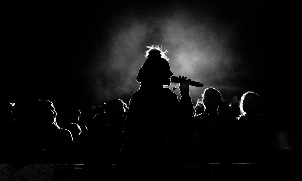 Women speaking in front of a crowed.