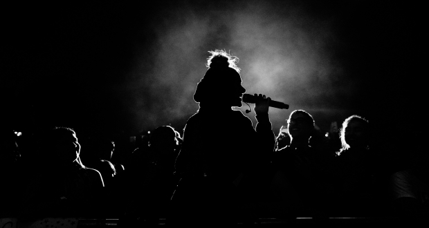 Women speaking in front of a crowed.