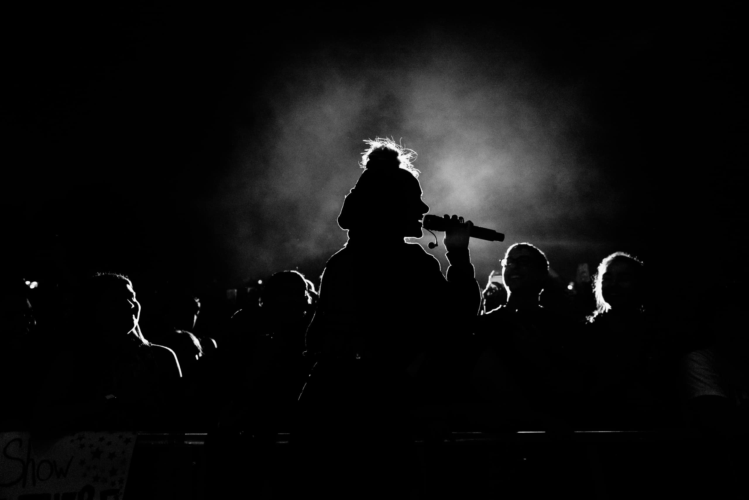 Women speaking in front of a crowed.