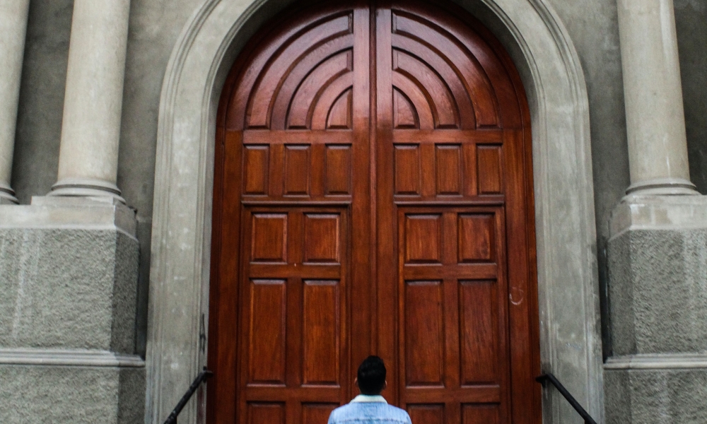 Man looking at a closed door