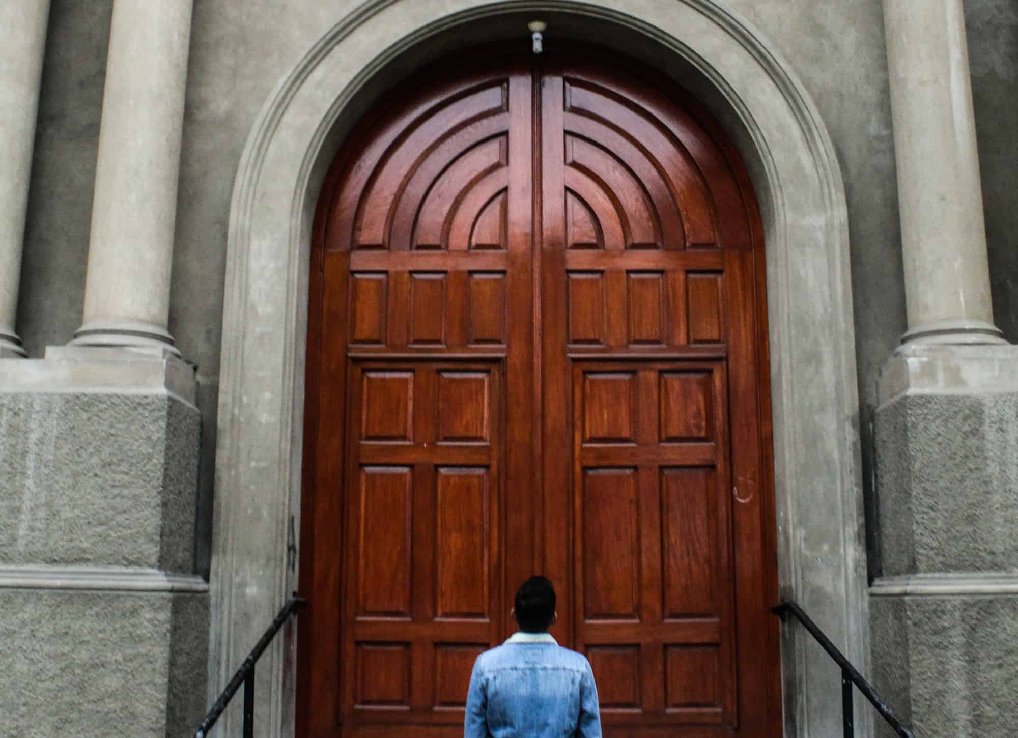 Man looking at a closed door