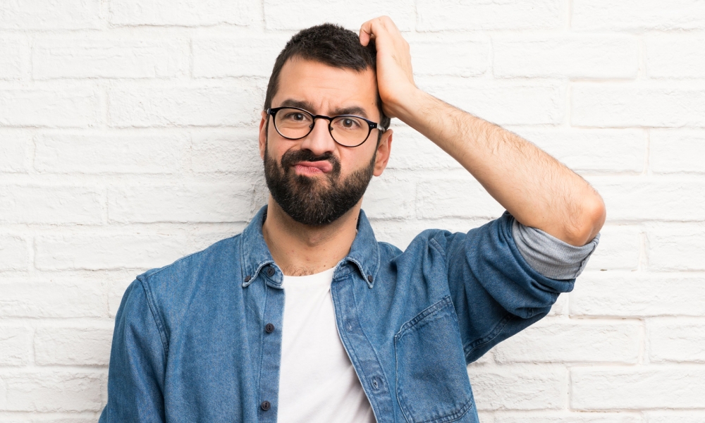 Man scratching his head