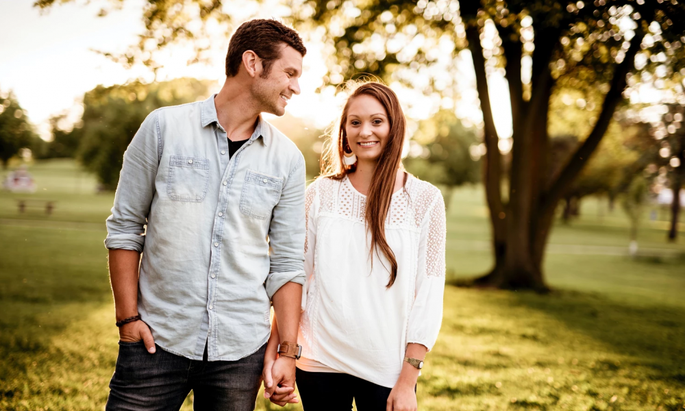 Couple holding hands and walking in the park