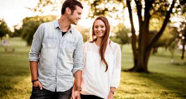 Couple holding hands and walking in the park