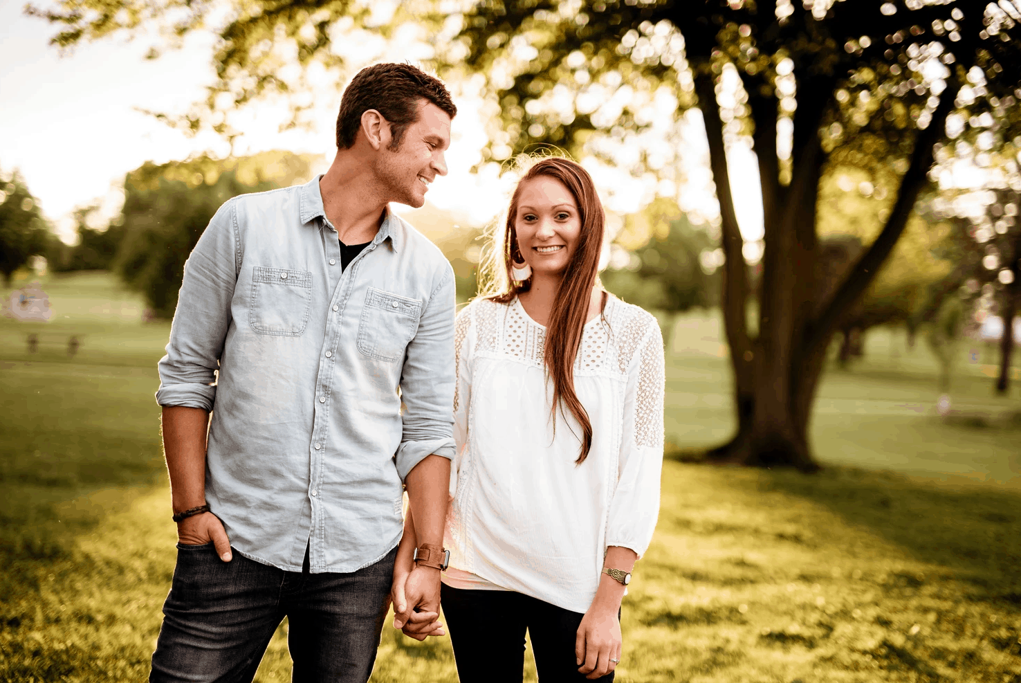 Couple holding hands and walking in the park