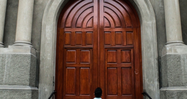 Man looking at a closed door