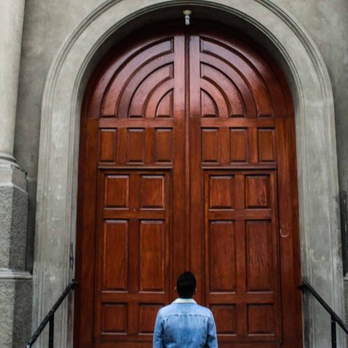 man-big-wooden-door